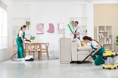 Professional cleaning service team working in room