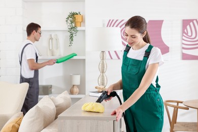 Professional cleaning service team working in room