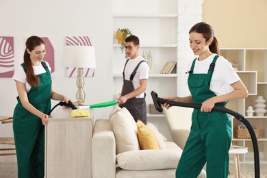 Professional cleaning service team working in room