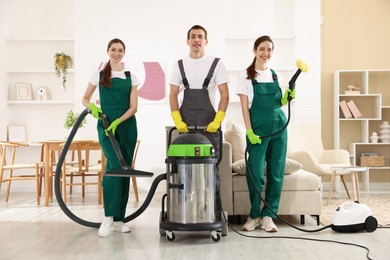 Cleaning service workers with equipment in room