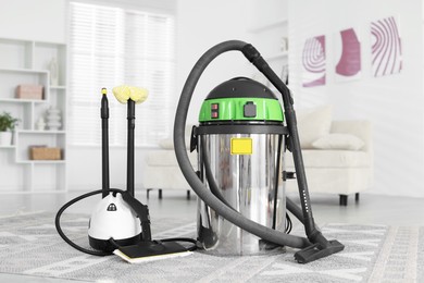 Photo of Professional hoover and vapor steam system at home. Cleaning appliances