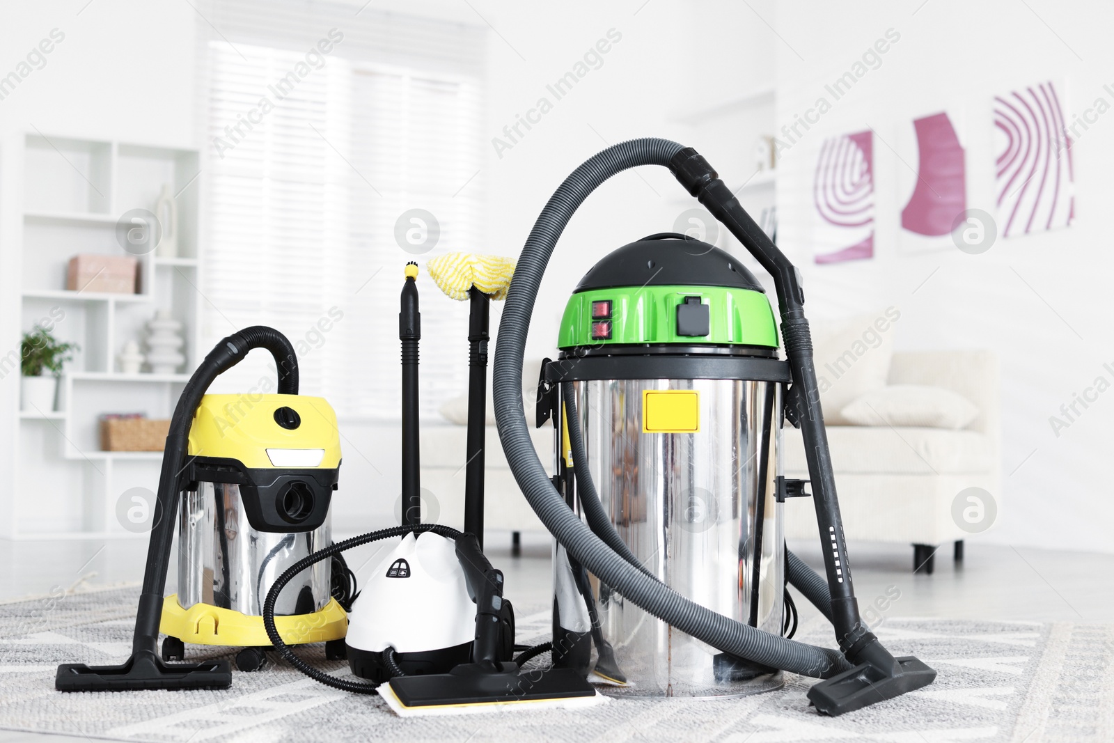 Photo of Professional hoovers and vapor steam system at home. Cleaning appliances