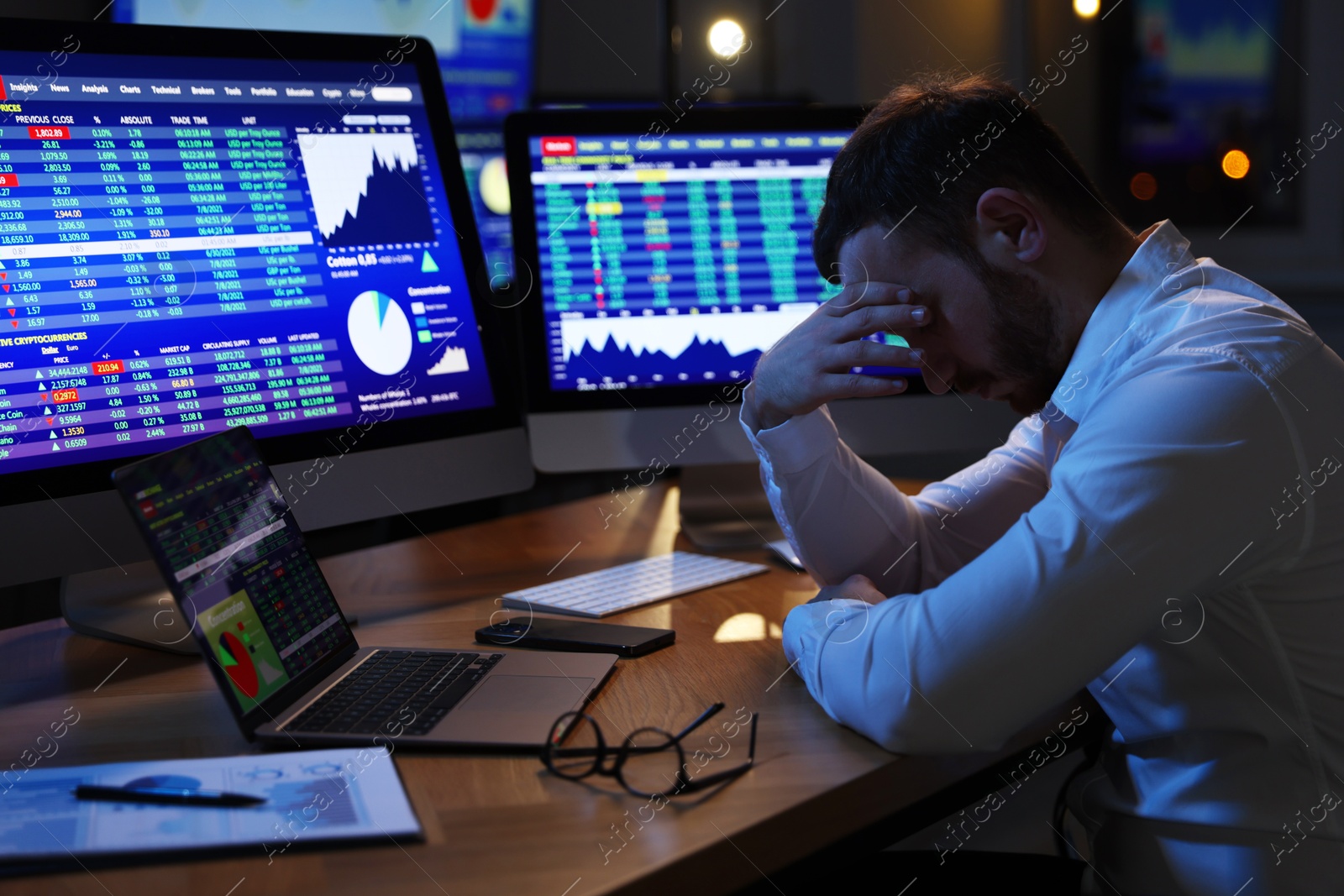 Photo of Tired overworked financial trading specialist napping in office at night