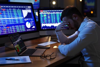 Tired overworked financial trading specialist napping in office at night