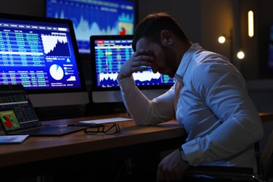 Tired overworked financial trading specialist napping in office at night