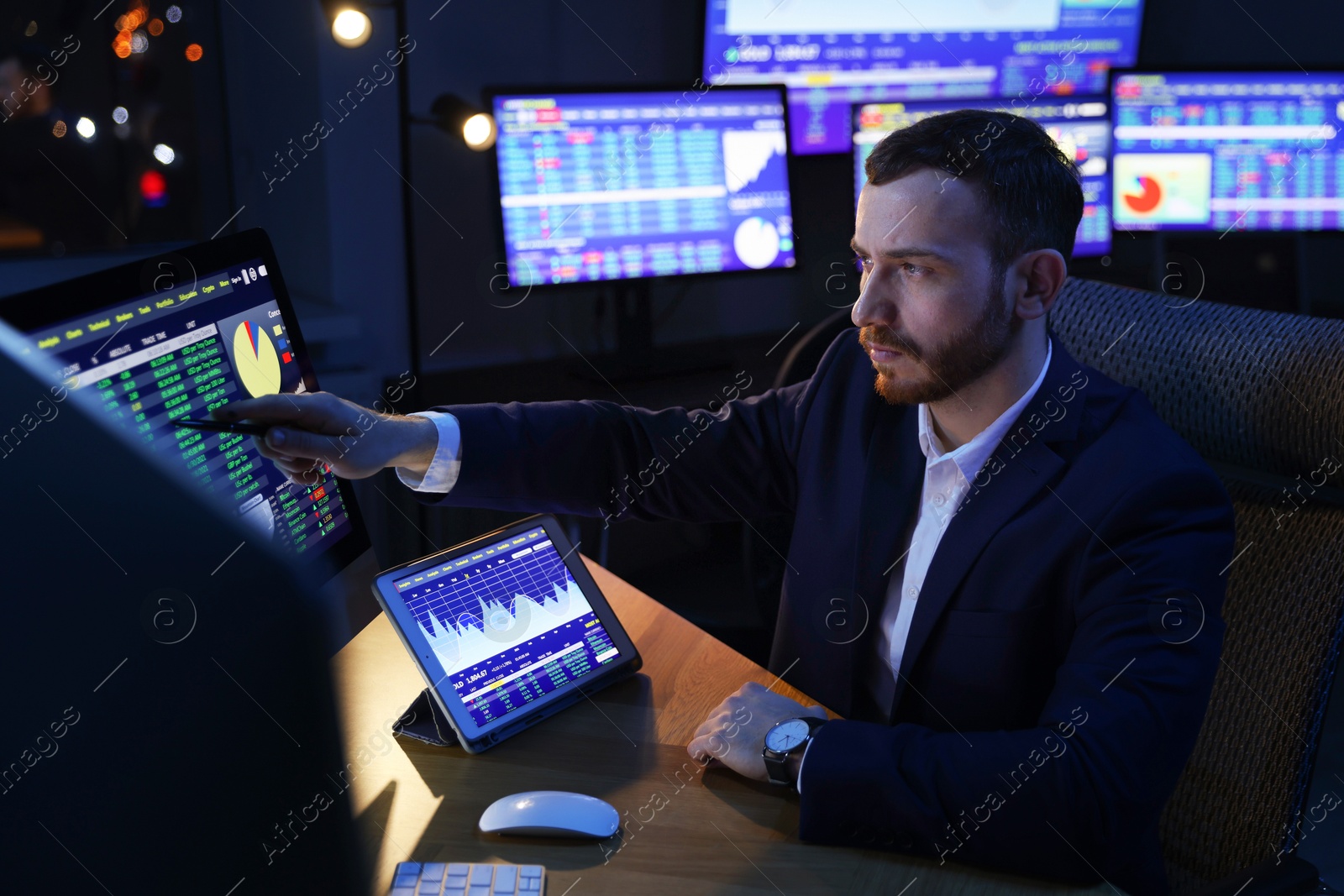 Photo of Financial trading specialist working in office at night