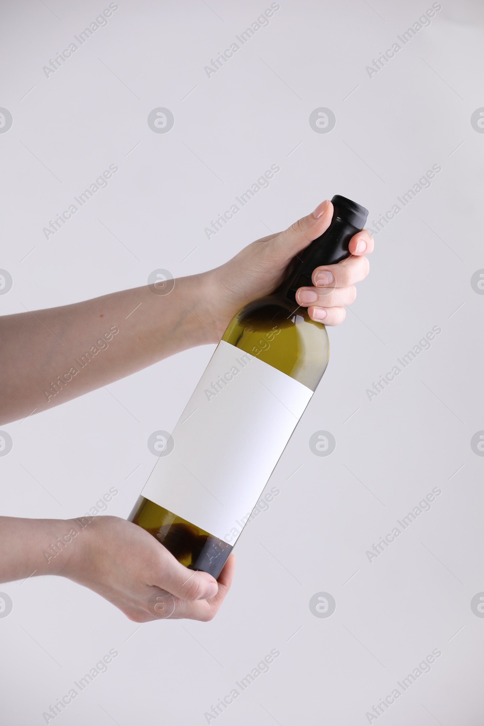 Woman with bottle of wine on white background, closeup Photo of Woman with bottle of wine on white background, closeup