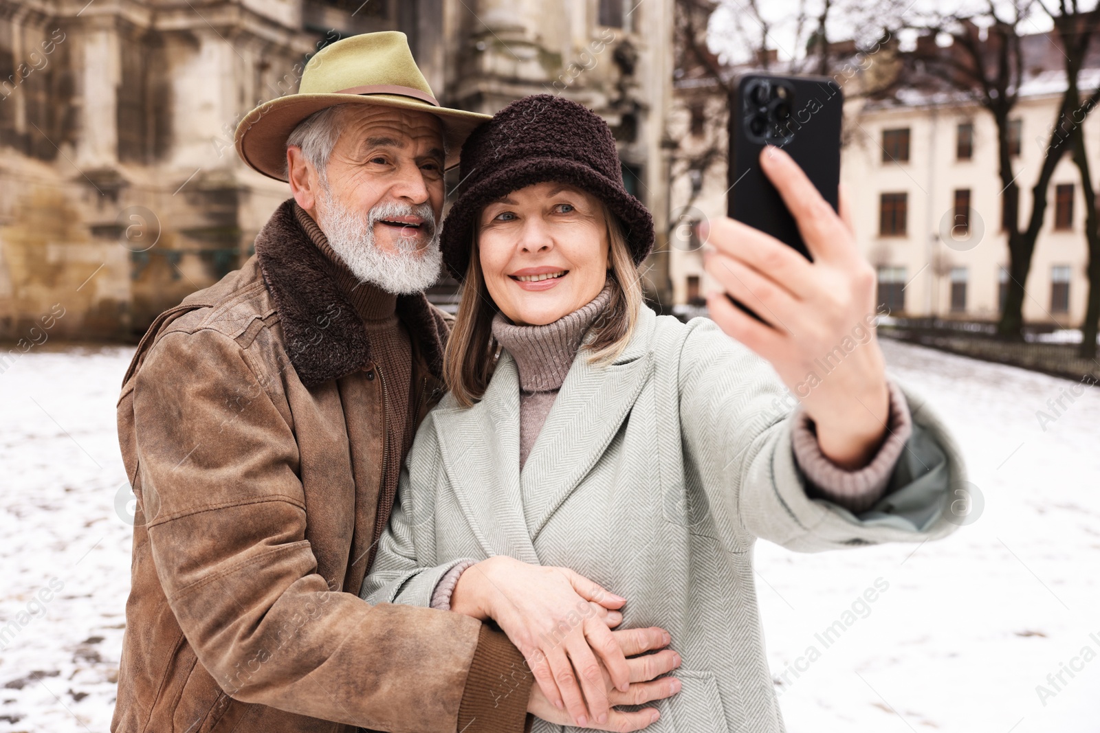 Photo of Happy senior couple taking selfie on winter day