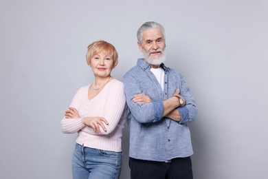 Portrait of lovely senior couple on grey background