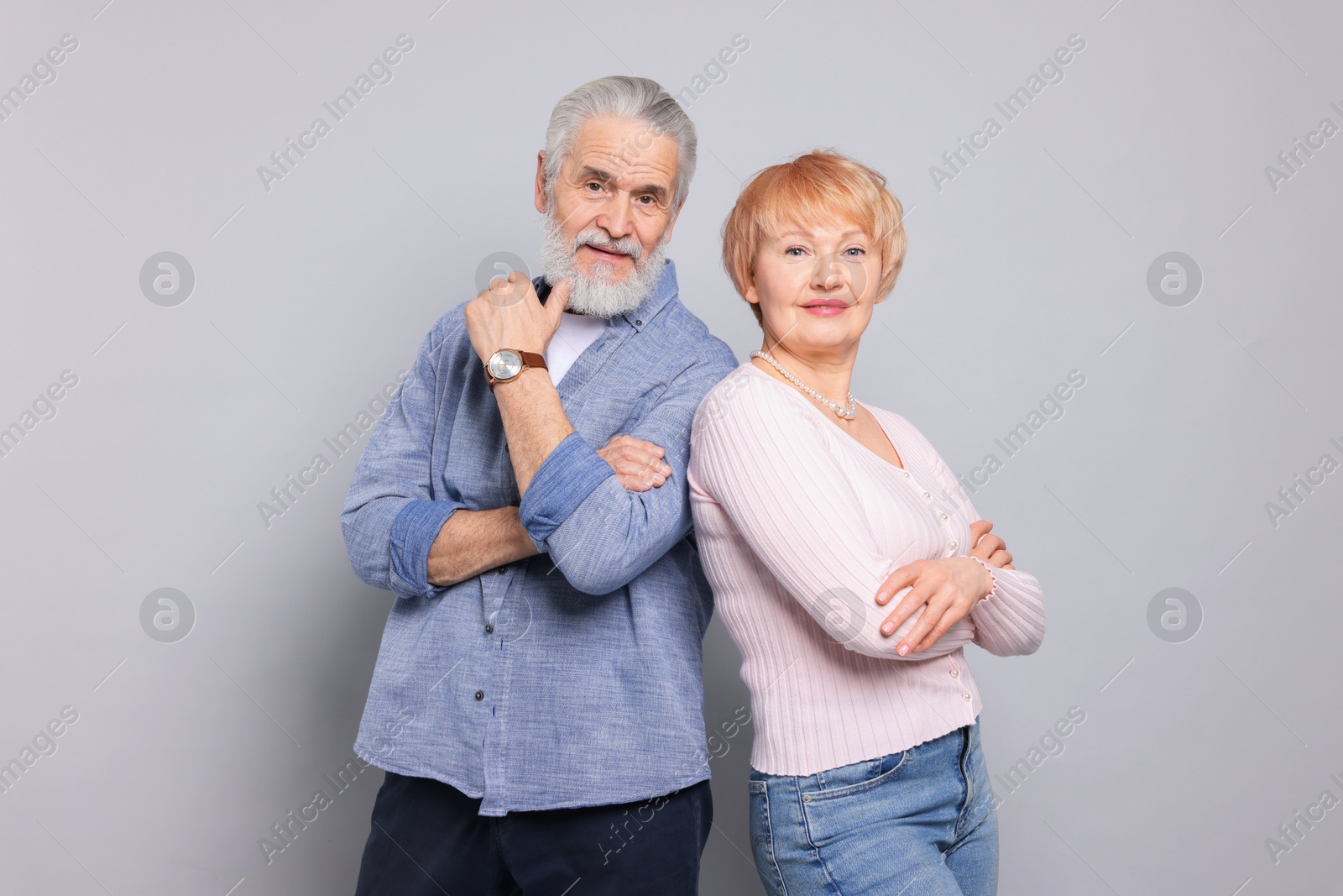 Photo of Portrait of lovely senior couple on grey background