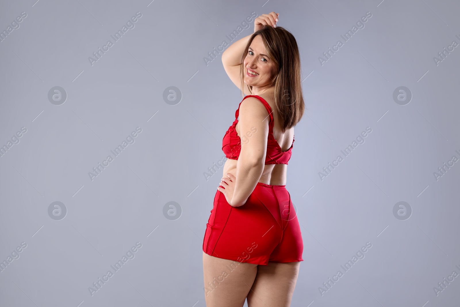 Photo of Woman in underwear on light grey background. Cellulite problem