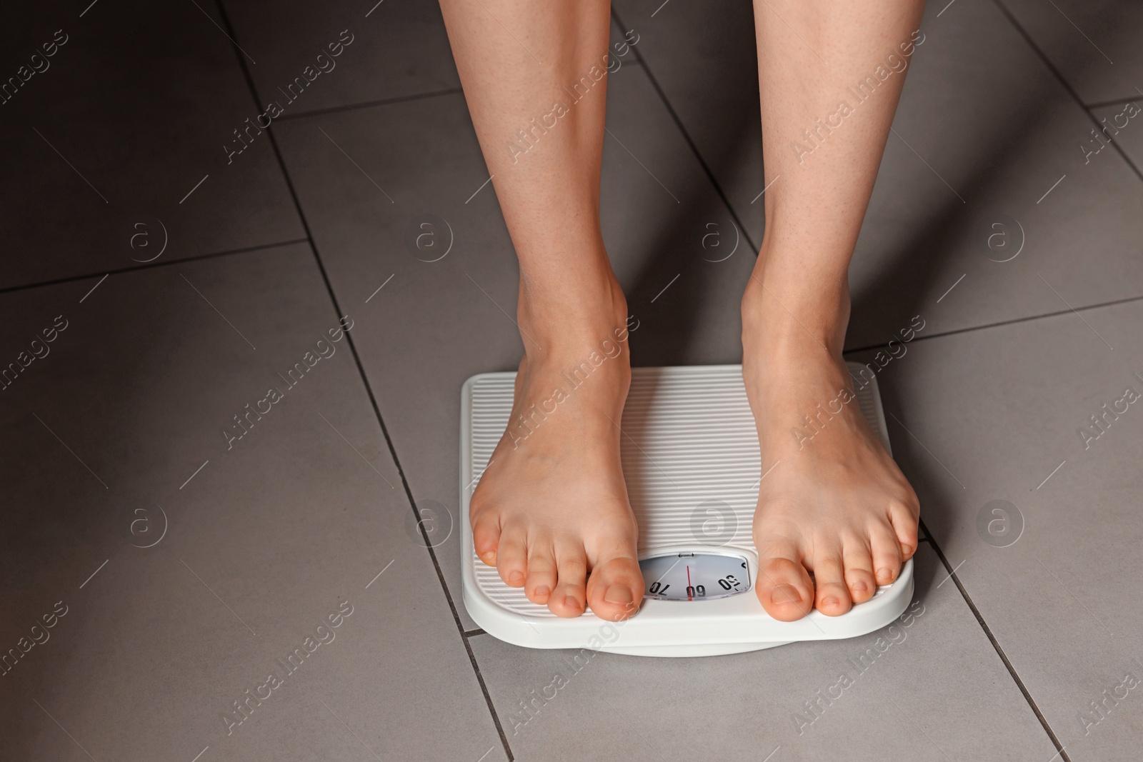 Photo of Bulimia problem. Woman on scales indoors, closeup. Space for text