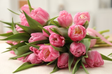 Photo of Bouquet of beautiful tulips on table, closeup