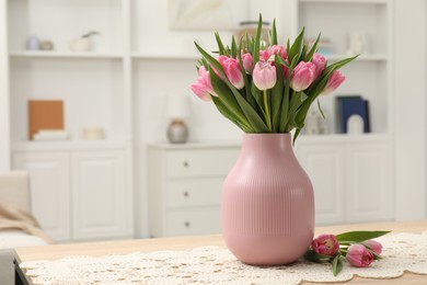 Photo of Bouquet of beautiful tulips in vase on table indoors, space for text