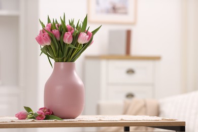 Photo of Bouquet of beautiful tulips in vase on table indoors, space for text