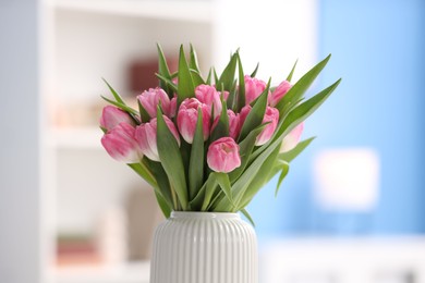 Photo of Bouquet of beautiful tulips in vase indoors, closeup