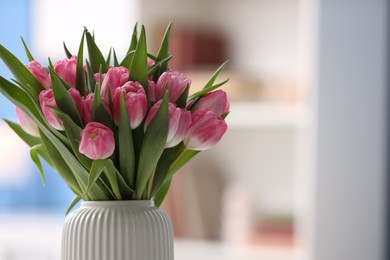 Photo of Bouquet of beautiful tulips in vase indoors, closeup. Space for text