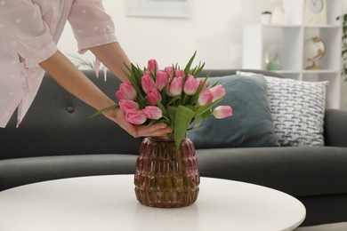 Photo of Woman with bouquet of beautiful tulips indoors, closeup