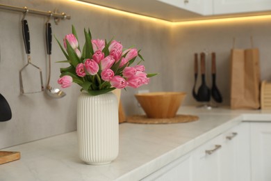 Photo of Bouquet of beautiful tulips in vase on white marble countertop indoors, space for text