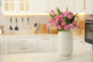 Photo of Bouquet of beautiful tulips in vase on white marble table indoors, space for text