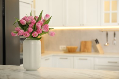 Photo of Bouquet of beautiful tulips in vase on white marble table indoors, space for text