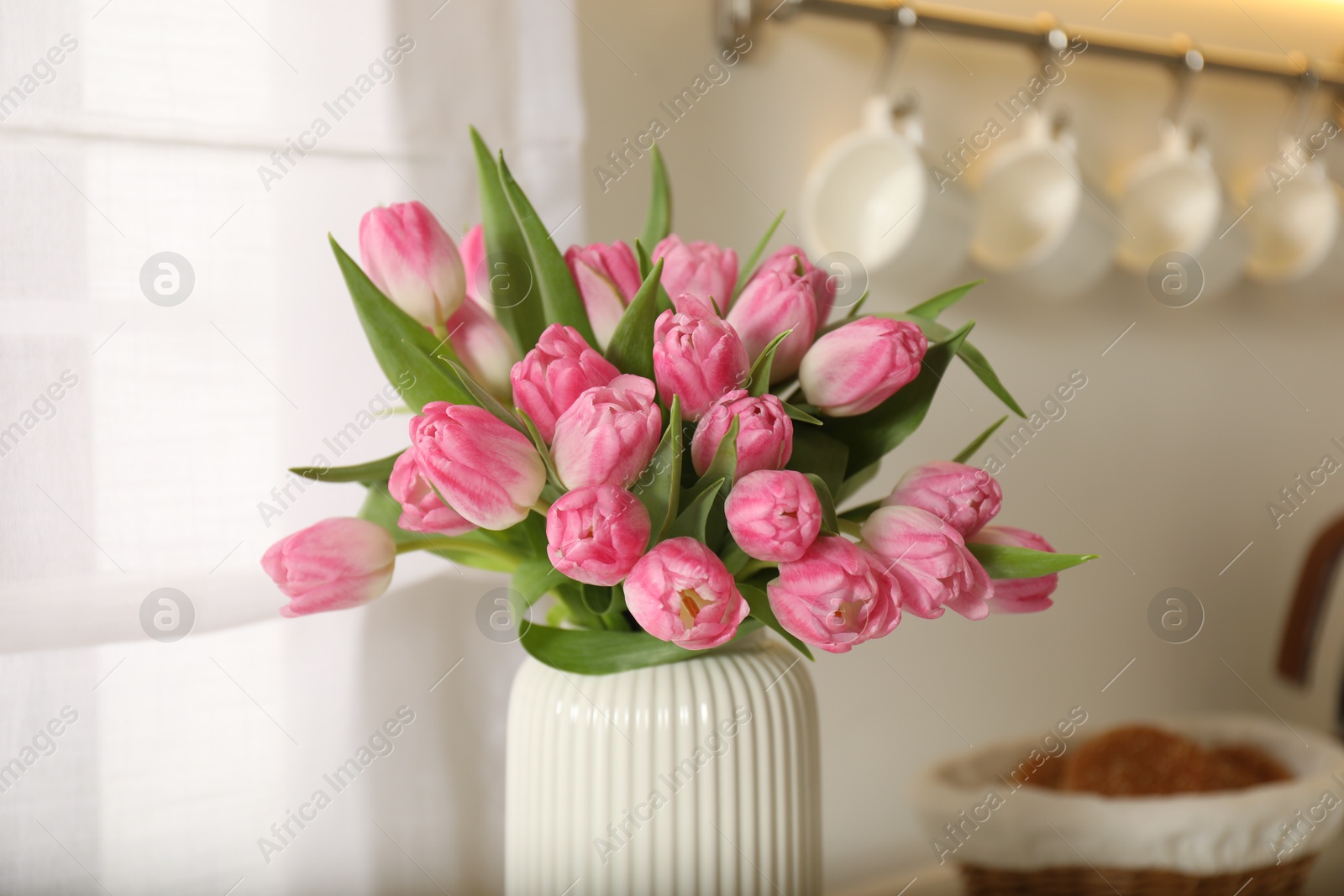 Photo of Bouquet of beautiful tulips in vase indoors, closeup