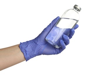 Photo of Doctor in medical glove holding bottle of medication on white background, closeup