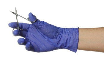 Photo of Doctor in medical glove holding scissors on white background, closeup