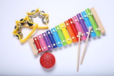 Flat lay composition with different toy musical instruments on white background