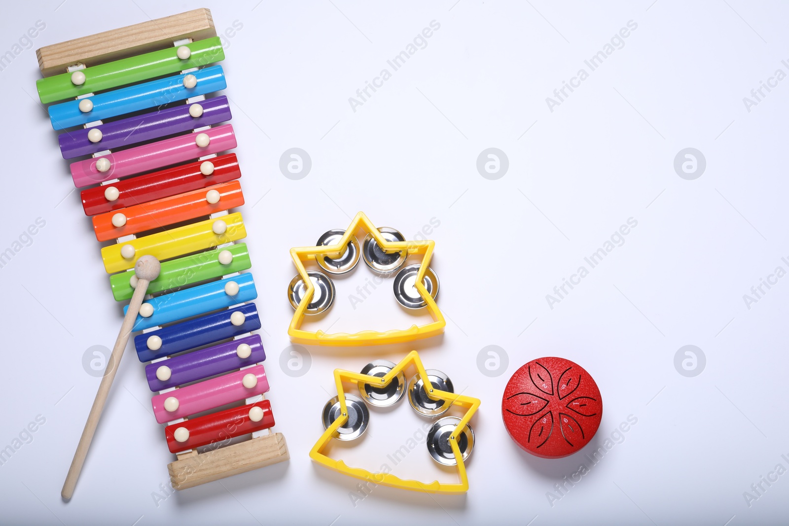 Photo of Flat lay composition with different toy musical instruments on white background. Space for text