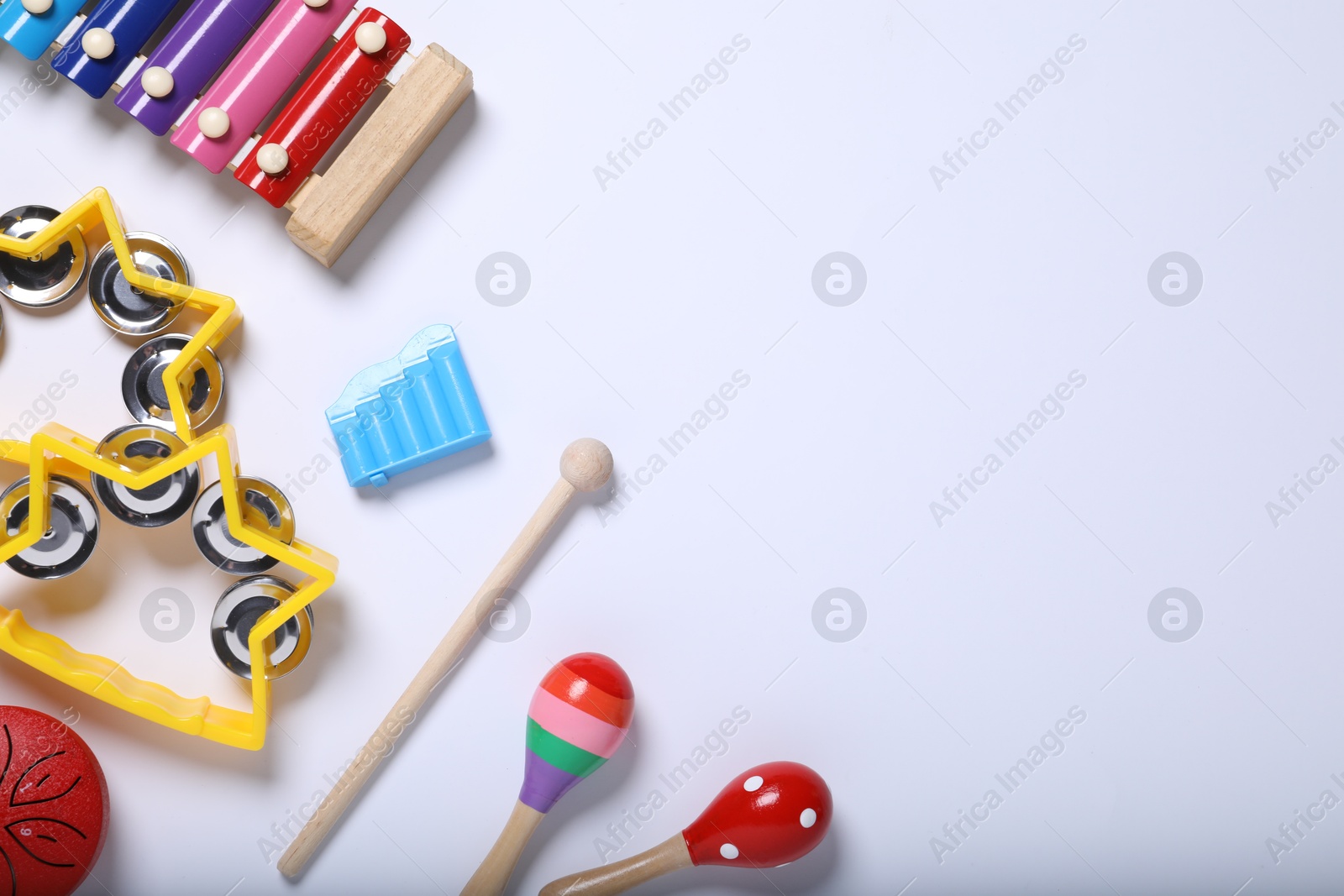 Photo of Flat lay composition with different toy musical instruments on white background. Space for text