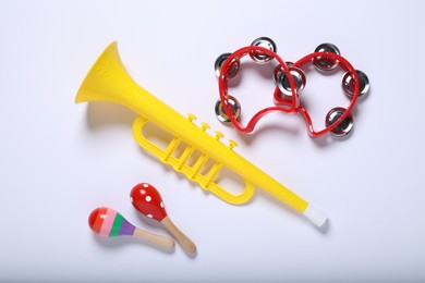 Flat lay composition with different toy musical instruments on white background