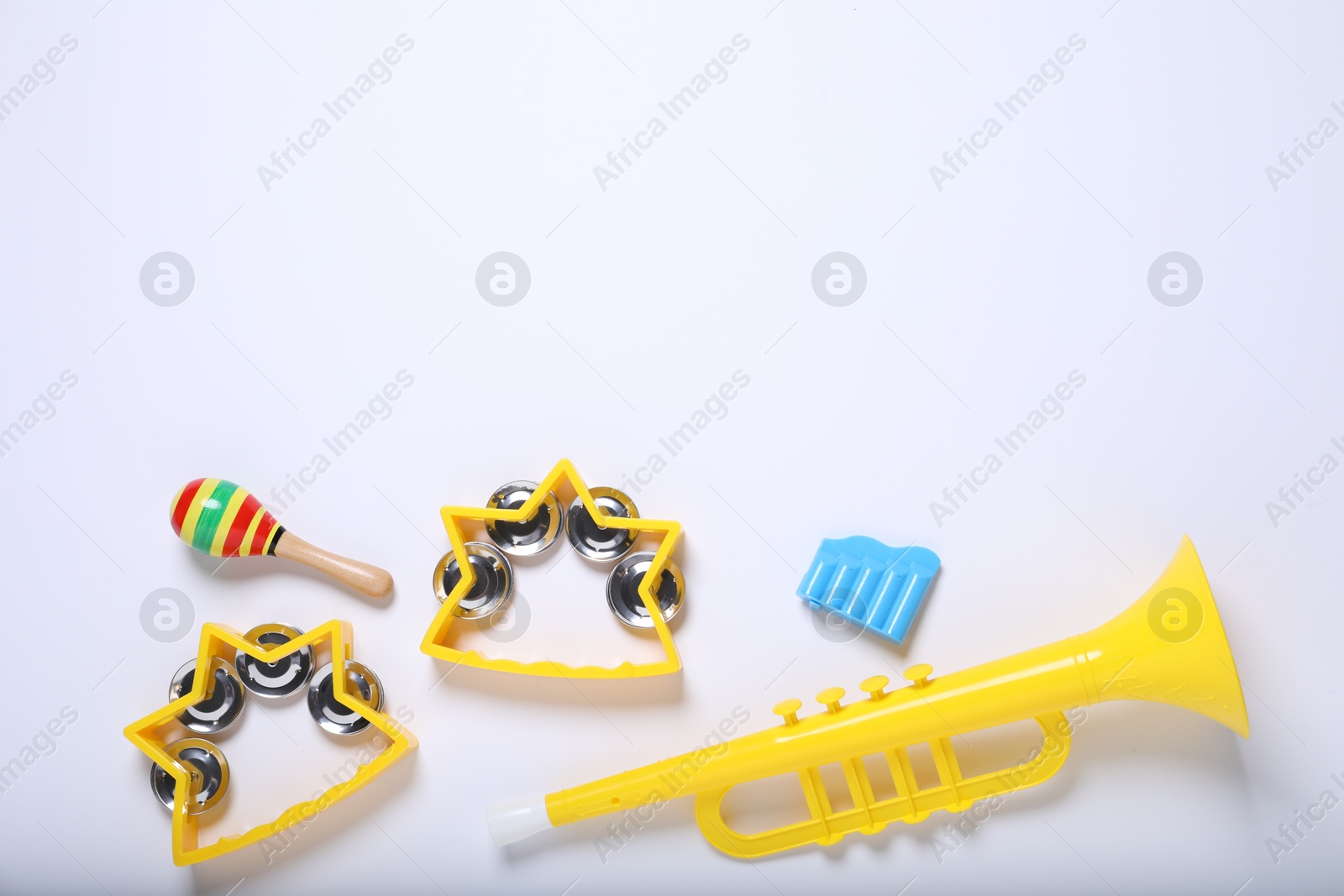 Photo of Flat lay composition with different toy musical instruments on white background. Space for text