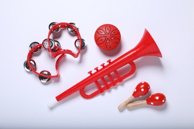 Flat lay composition with different toy musical instruments on white background