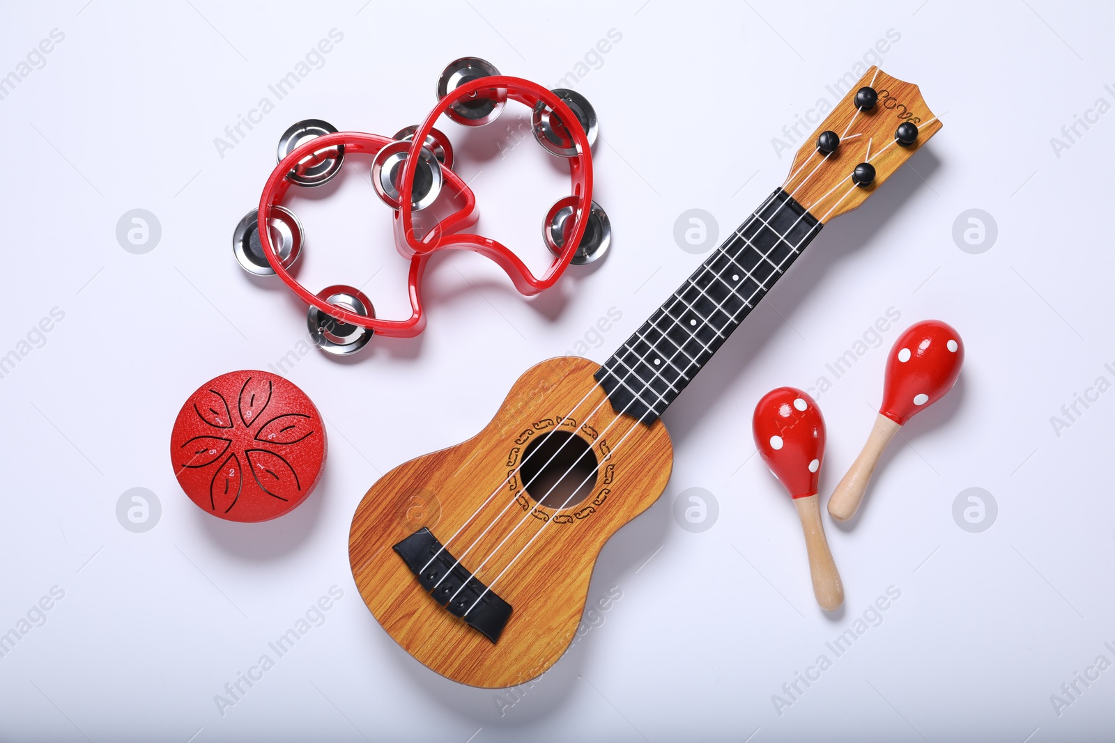 Photo of Flat lay composition with different toy musical instruments on white background