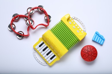 Flat lay composition with different toy musical instruments on white background