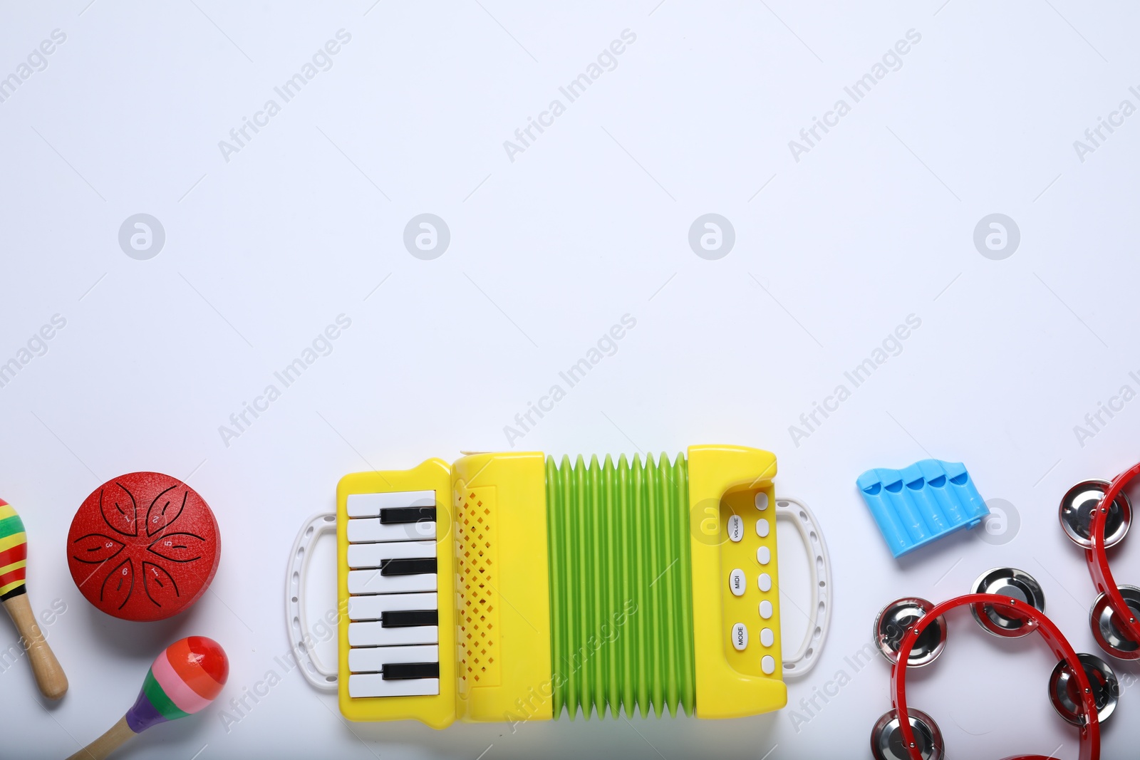 Photo of Flat lay composition with different toy musical instruments on white background. Space for text