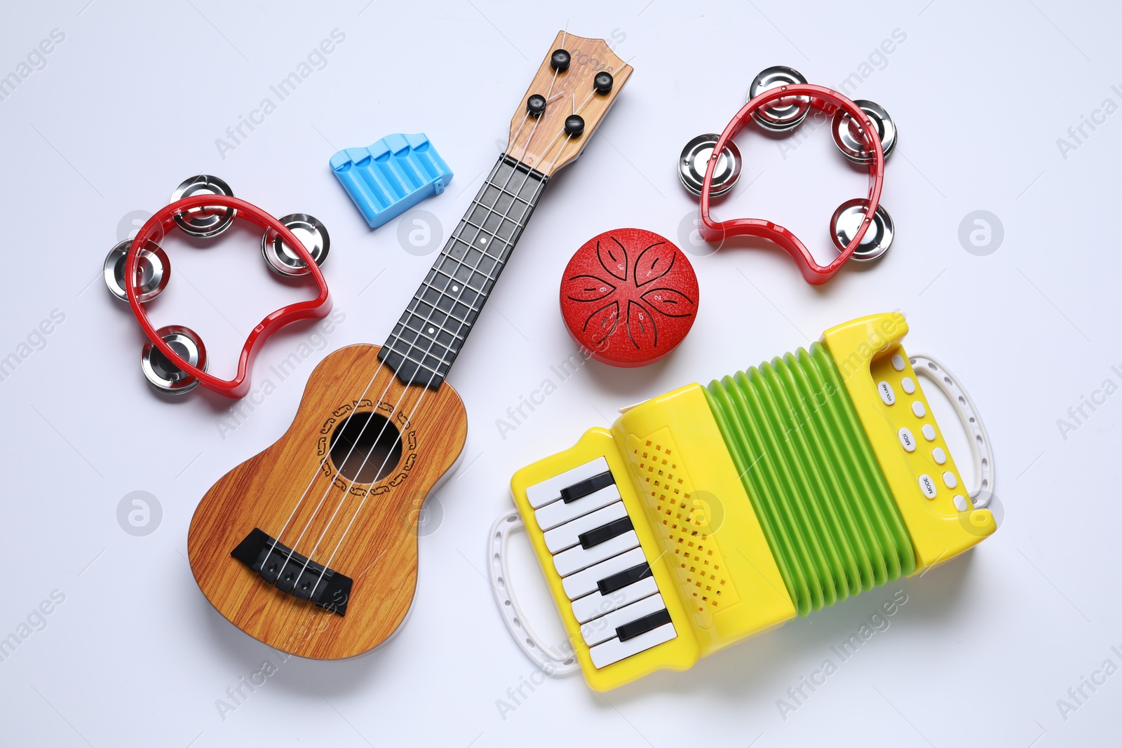 Photo of Flat lay composition with different toy musical instruments on white background