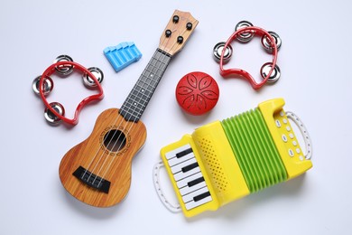 Flat lay composition with different toy musical instruments on white background