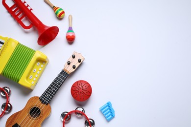 Photo of Flat lay composition with different toy musical instruments on white background. Space for text