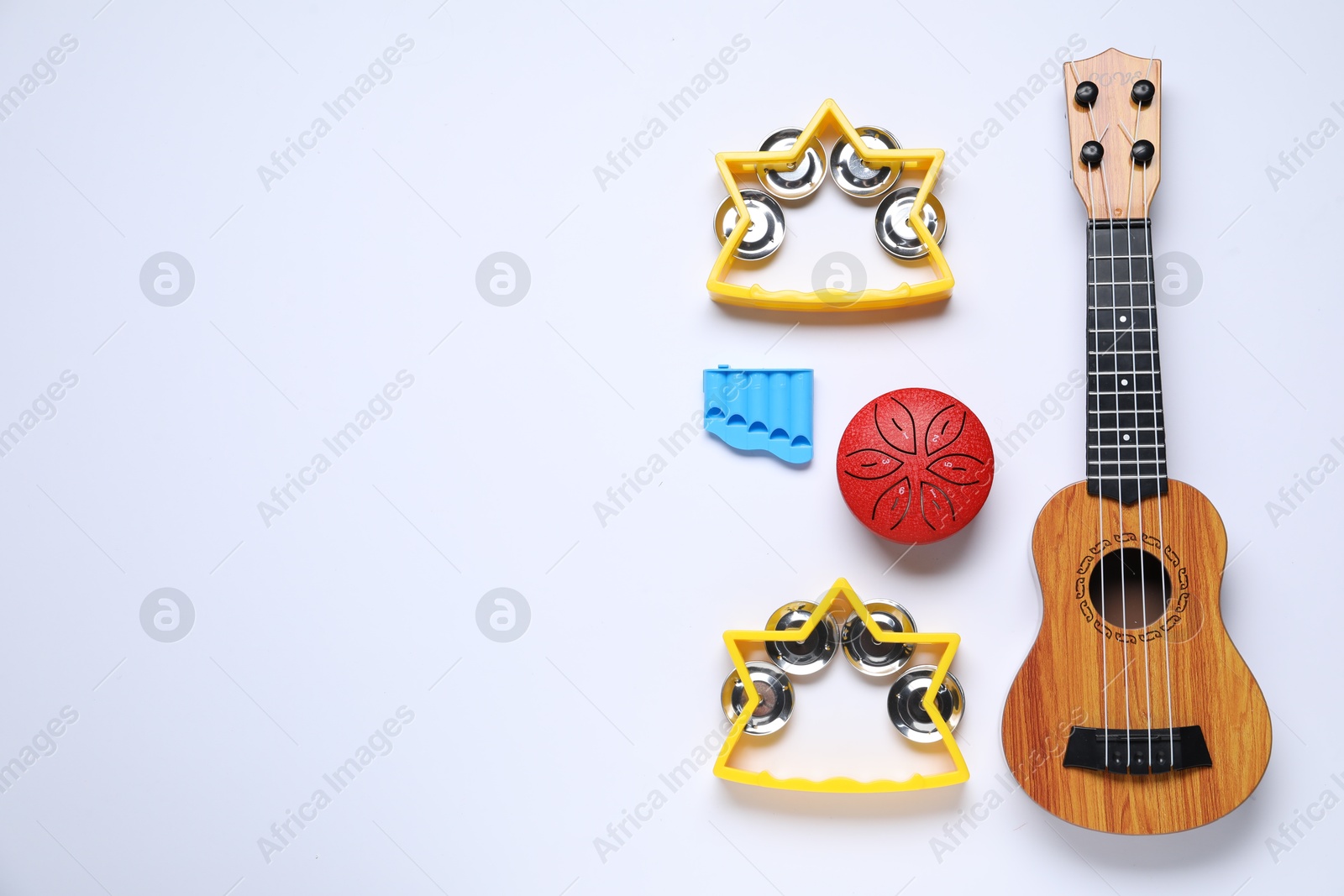 Photo of Flat lay composition with different toy musical instruments on white background. Space for text