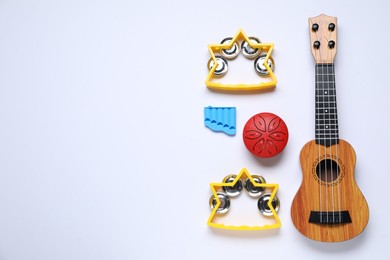 Photo of Flat lay composition with different toy musical instruments on white background. Space for text