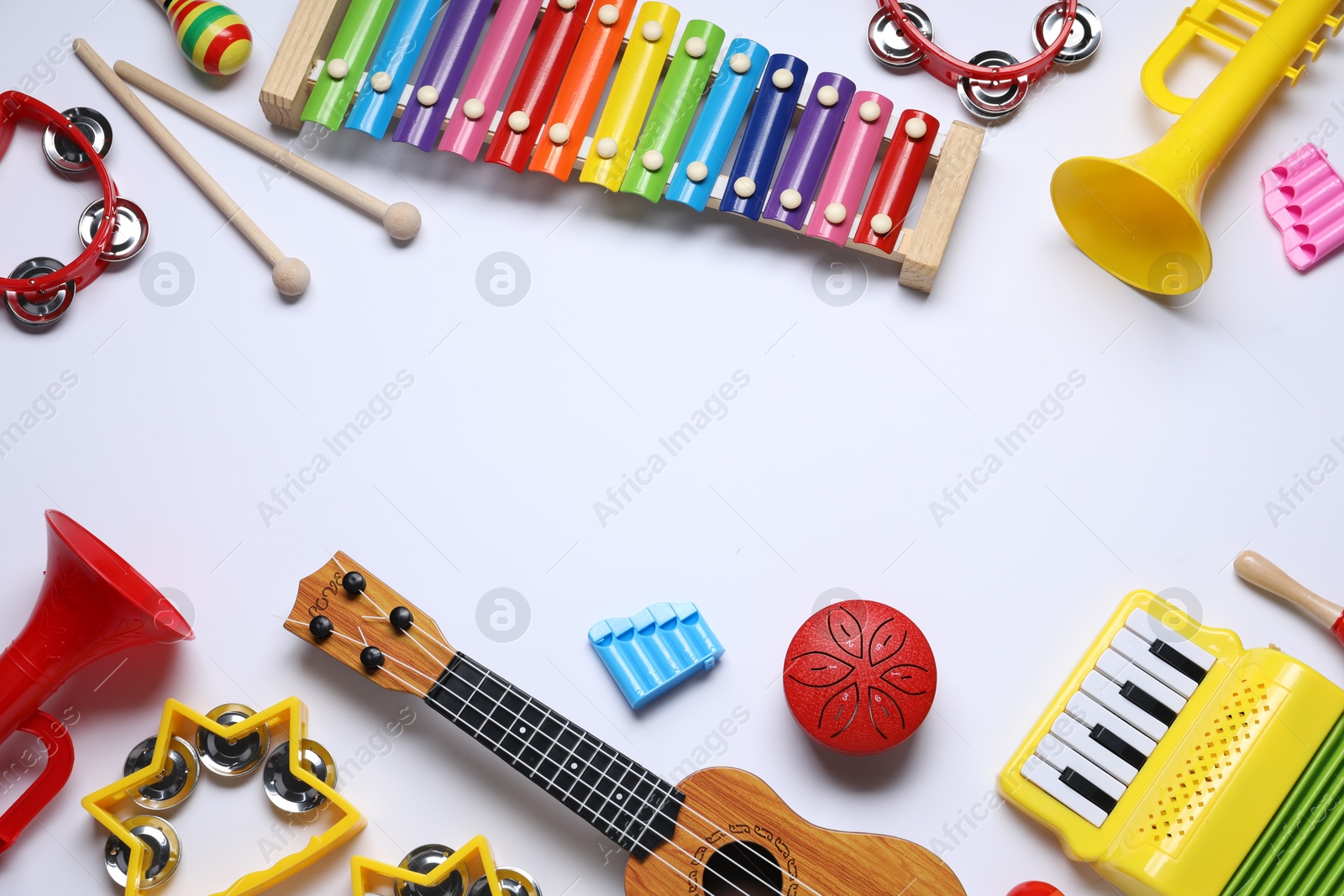 Photo of Flat lay composition with different toy musical instruments on white background. Space for text