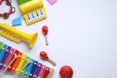 Flat lay composition with different toy musical instruments on white background. Space for text