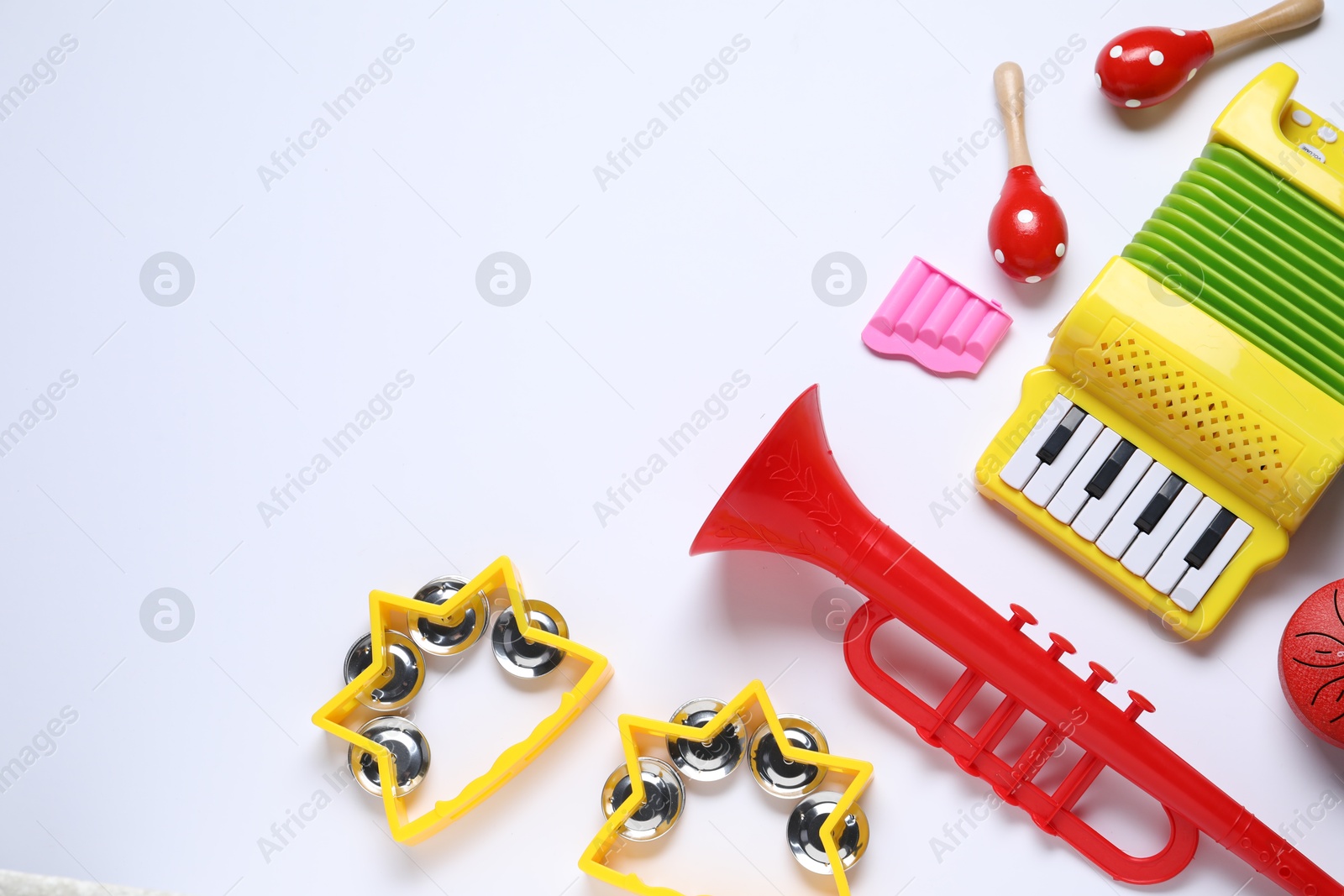 Photo of Flat lay composition with different toy musical instruments on white background. Space for text