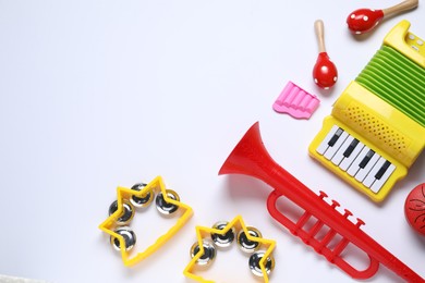 Flat lay composition with different toy musical instruments on white background. Space for text