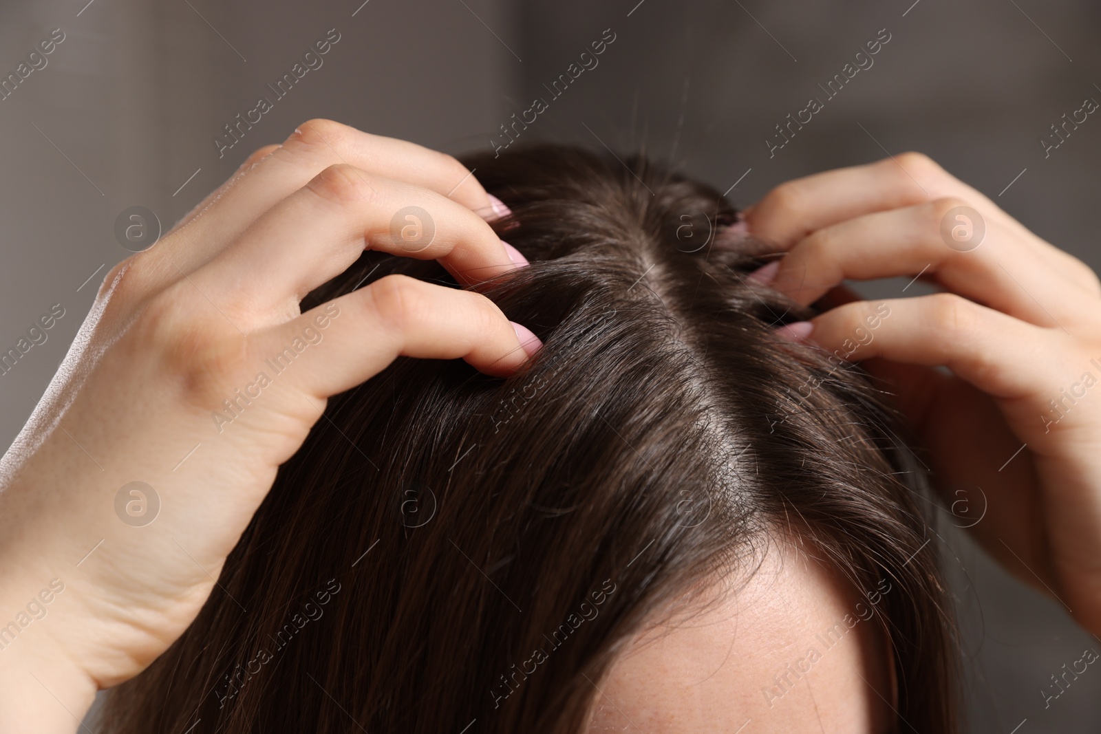 Photo of Woman with healthy hair roots on blurred background, closeup