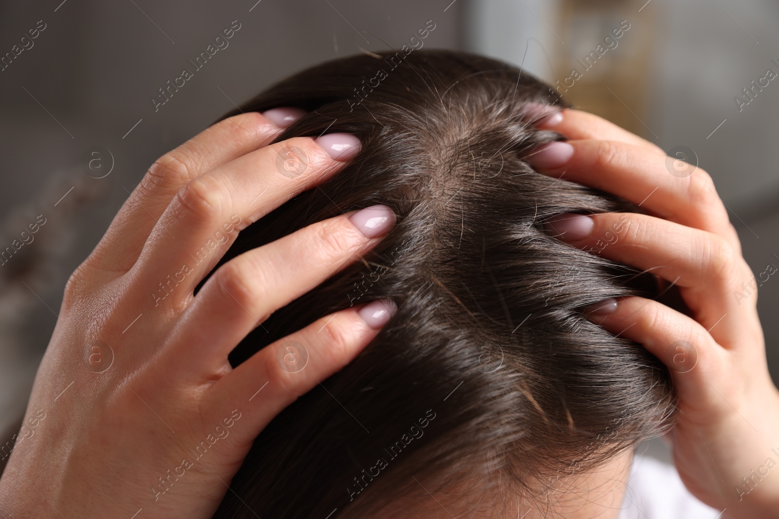 Photo of Woman with healthy hair roots on blurred background, closeup