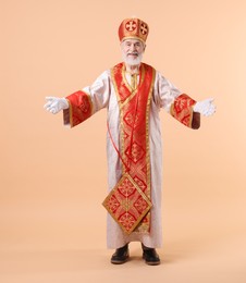 Full length portrait of happy Saint Nicholas on beige background