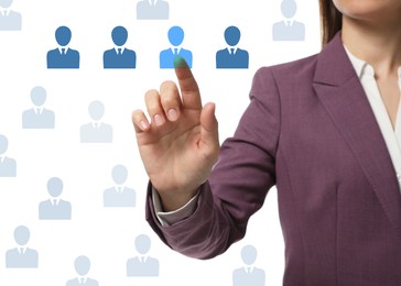 Image of Targeting, recruitment, customer acquisition. Business woman touching virtual screen with human icons against white background, closeup